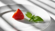 © Igor - Sliced Strawberry with Basil Leaf on White Plate