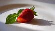 © Igor - Fresh strawberry with green leaves on white plate