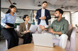 © fizkes - Team leader explaining corporate strategy, exchange ideas, expressing business decisions with diverse colleagues during briefing in corporate office. Leadership, collaboration, and strategic planning