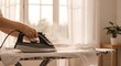 © RAHENA - Ironing a shirt on a board in a bright room