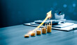 © Sutthiphong - Gold market investment growth concept with rising stacked coins and upward arrow chart representing precious metal price increase, gold trading opportunity, financial security