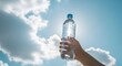 © MSTLIMA - World water day conservation hand holding water bottle under cloudy blue sky promoting sustainability and hydration