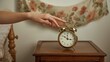 © LimeSky - Woman's hand silencing an old-fashioned twin bell alarm clock