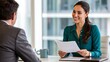 © millennium - Professional job interview meeting with businesswoman reviewing resume and smiling during recruitment discussion