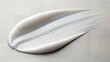 © abufahim - White plastic headband isolated on light gray background minimalist beauty accessory