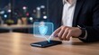 © CreativeLoom - Businessman tapping smartphone with holographic shield security icon AI Cybersecurity Scam Prevention concept