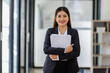 © David - A smiling businesswoman embracing her documents in a cozy, modern office space, representing warmth, professionalism, and a proactive approach to her work life.