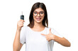 © luismolinero - Young Russian woman holding car keys over isolated chroma key background with surprise facial expression