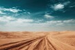 © Nazlin - Vast desert landscape with winding tire tracks leading towards the horizon under a dramatic blue sky with scattered clouds.