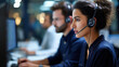 © Laura - Call center workers wearing headsets and working at computer stations in a professional office, defocused background, customer support team concept, with copy space