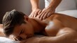 © The Little Hut - Man Receiving a Relaxing Back Massage in Spa for Wellness and Muscle Relaxation