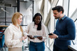 © Marko - Group of people discussing work at a modern office during daytime in a large open space