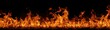 © Qori - Vibrant orange and red flames dancing against a dark black background.