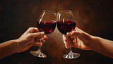 Two hands raise glasses of red wine in a toast symbolizing celebration and connection