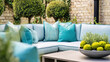 © Anna Studio - Outdoor sectional sofa with teal pillows creating an inviting patio seating area amidst lush backyard landscaping