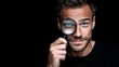 © Nataliia_Trushchenko - Male individual holding a magnifying glass to his eye, showcasing facial features and expression against a dark background with a focus on the lens