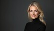 © Vadym - Middle aged blonde woman in black turtleneck looks at camera with slight smile. Hair wavy, styled. Wears elegant pearl earrings. Clean studio portrait against dark gray background, side profile.