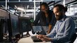 © DC Studio - Data center system administrators working together, collaborating on neural network software development. Server hub worker and african american colleague implementing AI tech in workplace, camera A
