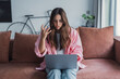 © Daniel - Angry young woman sit on sofa in living room frustrated having operational problems working on laptop, mad millennial girl feel stressed confused with slow internet connection or computer spam