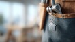 © JuliaDorian - Close-up of house keychain hanging from tool belt, showcasing craftsmanship and attention to detail in a modern workspace environment