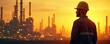 © Viktor - Man in hard hat watches refinery complex at sunset. Industrial landscape with towers and lights under warm sky. Worker observes plant operations at twilight.