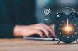 © chaylek - Marketing professionals manage time efficiently using digital planning tools. Alarm clock with virtual icons represents productivity, deadline control, workflow optimization, modern work efficiency