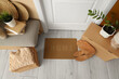 © Pixel-Shot - Doormat with cardboard boxes and soft bench in hallway on moving day, top view