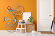 © Pixel-Shot - Cardboard boxes with stool and bicycle near door in hallway on moving day