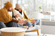 © Pixel-Shot - Frozen family with plaid warming near electric convector heater at home
