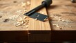 © Xingguo - jointer. Close-up of a woodworking blade pressing against a wooden board, creating shavings. safety posters, maintenance manuals, designed for precision metalworking and fabrication facilities.