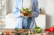 © Pixel-Shot - Young woman with glass bowl of fresh vegetable salad in kitchen