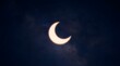 © FRAME FLOW - Stunning view of a partial solar eclipse, where the moon casts its shadow, creating a brilliant crescent sun against the dark sky