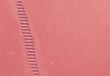 © DesignSells - Diagonal tire tread imprint across textured pink sand beach close-up