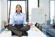 © Westend61 - Manager practicing mindfulness meditation at office for stress relief