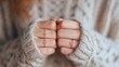 © tashechka - Hands show rings in warm setting with sweater and soft light in background