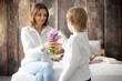 © Tomsickova - Cute little boy, giving flowers to his mom for Mothers day