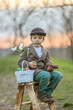 © Tomsickova - Beautiful stylish toddler child, boy, playing with Easter decoration in the park, springtime