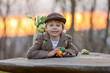 © Tomsickova - Beautiful stylish toddler child, boy, playing with Easter decoration in the park, springtime