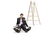 © Ljupco Smokovski - Man in a ruined suit sitting on the floor next to a ladder