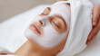 © Kateryna Arkhypova - Partial view cosmetologist applying clay mask, female face spa salon, serene young woman receiving facial treatment, white spa chair eyes closed relaxing, with copy space