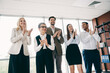 © deagreez - Professional team celebrating achievement with applause during a workplace meeting in an office environment