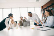 © deagreez - Team conflict arising during workplace meeting with business professionals discussing issues in corporate office setting
