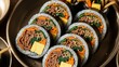 © Photo Moon - Korean kimbap rolls with beef bulgogi spinach carrots and egg in bamboo steamer traditional asian food preparation