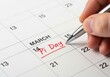 © MDABDULKADIR - Hand writing pi day on a calendar with a silver pen on isolated white background
