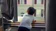 © Marco - Young boy leaning on windowsill, gazing outside, deep in thought, quiet moment of reflection, childhood curiosity, urban home setting, observing city life, daydreaming