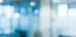 © birulaut - Blurred interior image showing light reflections and soft outlines of a modern office space with glass walls and blurred furniture in the background.