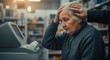 © arsyi_06 - Elderly Woman Struggles with Computer Showing Frustration and Confusion in Store.