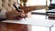 © Khansa - Close up of a hand signing an important contract with a premium pen at a professional desk, signifying a crucial business agreement and commitment.