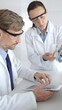© rogerphoto - Medical researchers, male and female, examining laboratory samples under microscope and digital tablet during joint scientific research. Medicine and science, teamwork concept