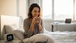 © sergiokat - Woman drinking coffee in bed at sunrise